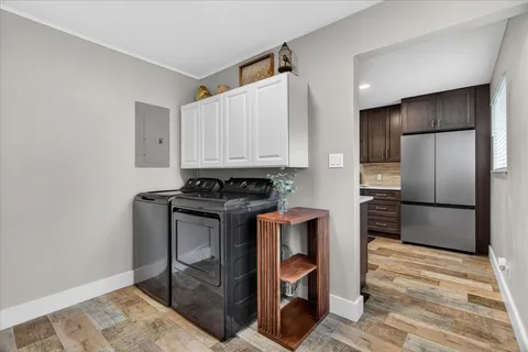 a kitchen with a refrigerator a stove and a cabinets
