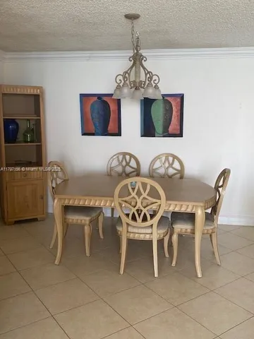 a dining room with furniture and chandelier