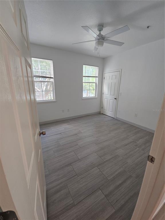 3446 Soho Street, Unit 108 Orlando, FL 32835 - Photo 13 of 39 wooden floor in an empty room with a window
