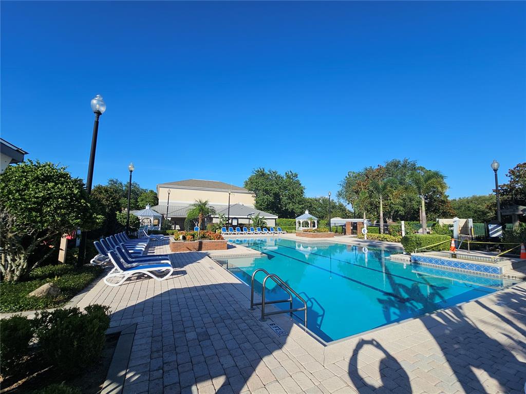 3446 Soho Street, Unit 108 Orlando, FL 32835 - Photo 17 of 39 a view of a patio with chairs and table