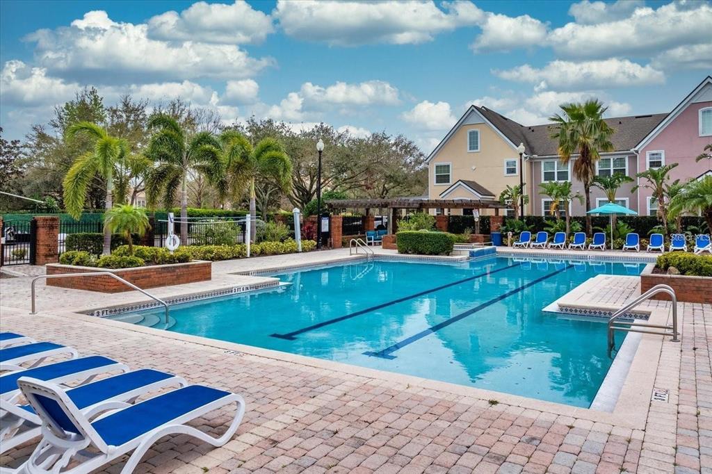 3446 Soho Street, Unit 108 Orlando, FL 32835 - Photo 18 of 39 a view of a swimming pool with a lounge chairs
