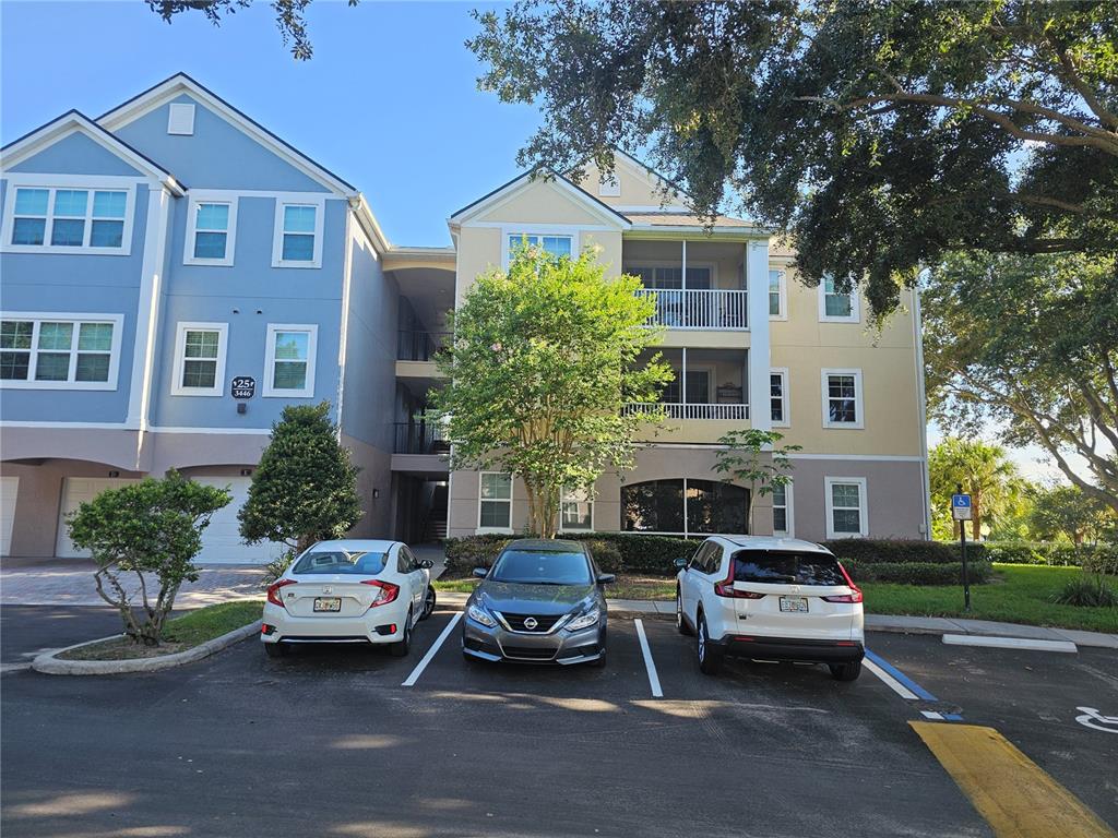 3446 Soho Street, Unit 108 Orlando, FL 32835 - Photo 2 of 39 a car parked in front of a brick house