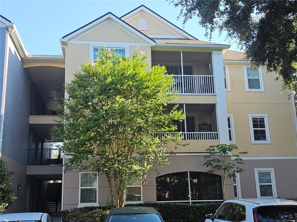 3446 Soho Street, Unit 108 Orlando, FL 32835 - Photo 3 of 39 a front view of a house with a garden
