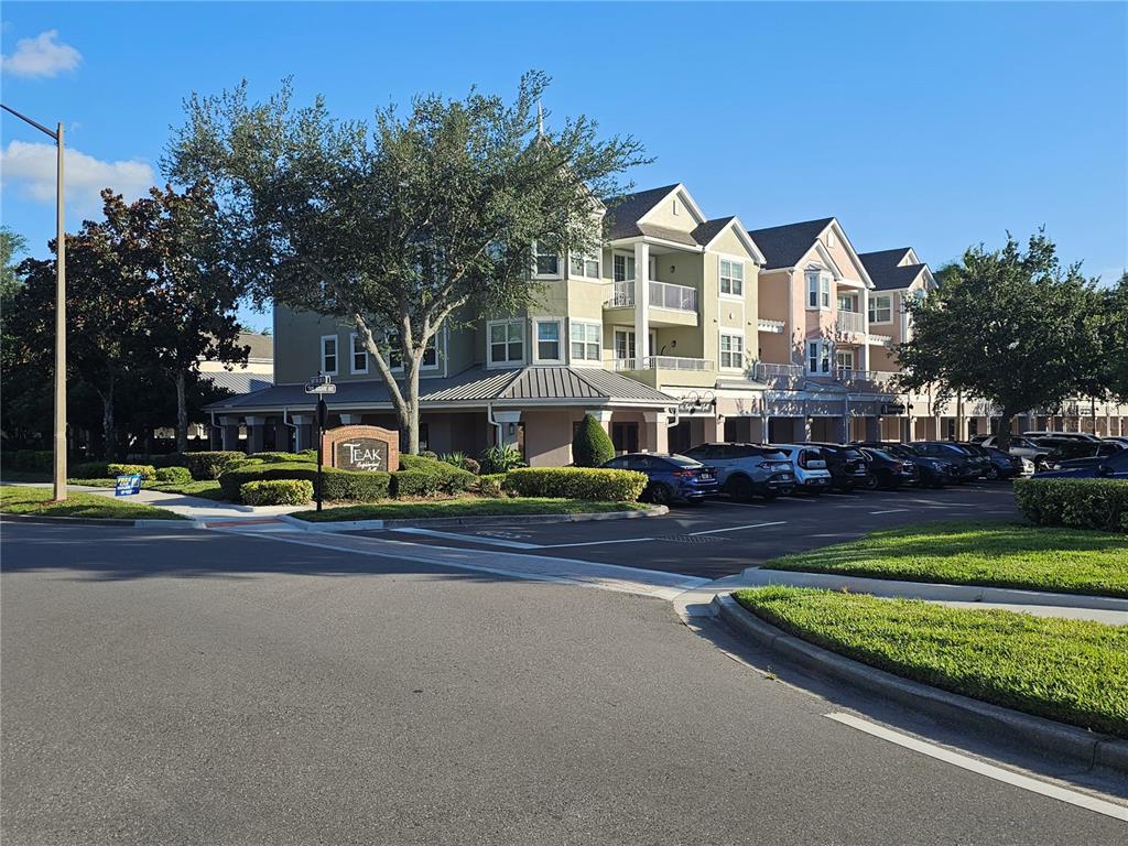3446 Soho Street, Unit 108 Orlando, FL 32835 - Photo 38 of 39 a front view of a house with a garden and trees