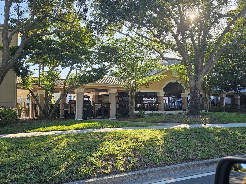 3446 Soho Street, Unit 108 Orlando, FL 32835 - Photo 39 of 39 a view of a house with a yard and large tree