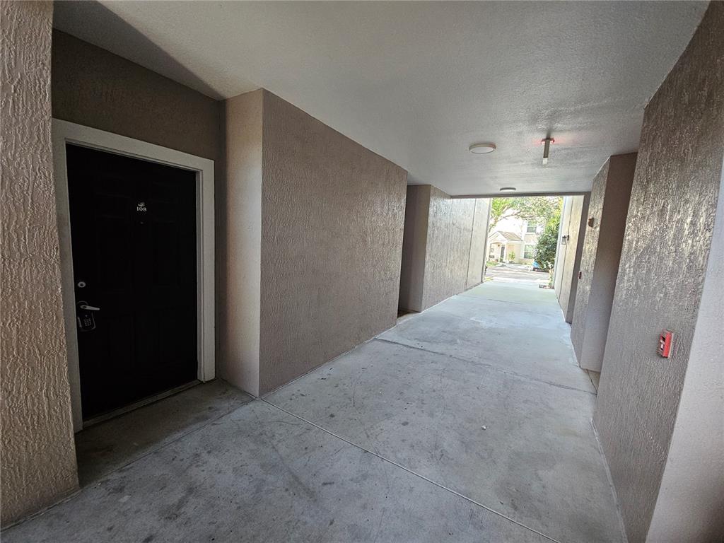 3446 Soho Street, Unit 108 Orlando, FL 32835 - Photo 4 of 39 a view of hallway with furniture and a window