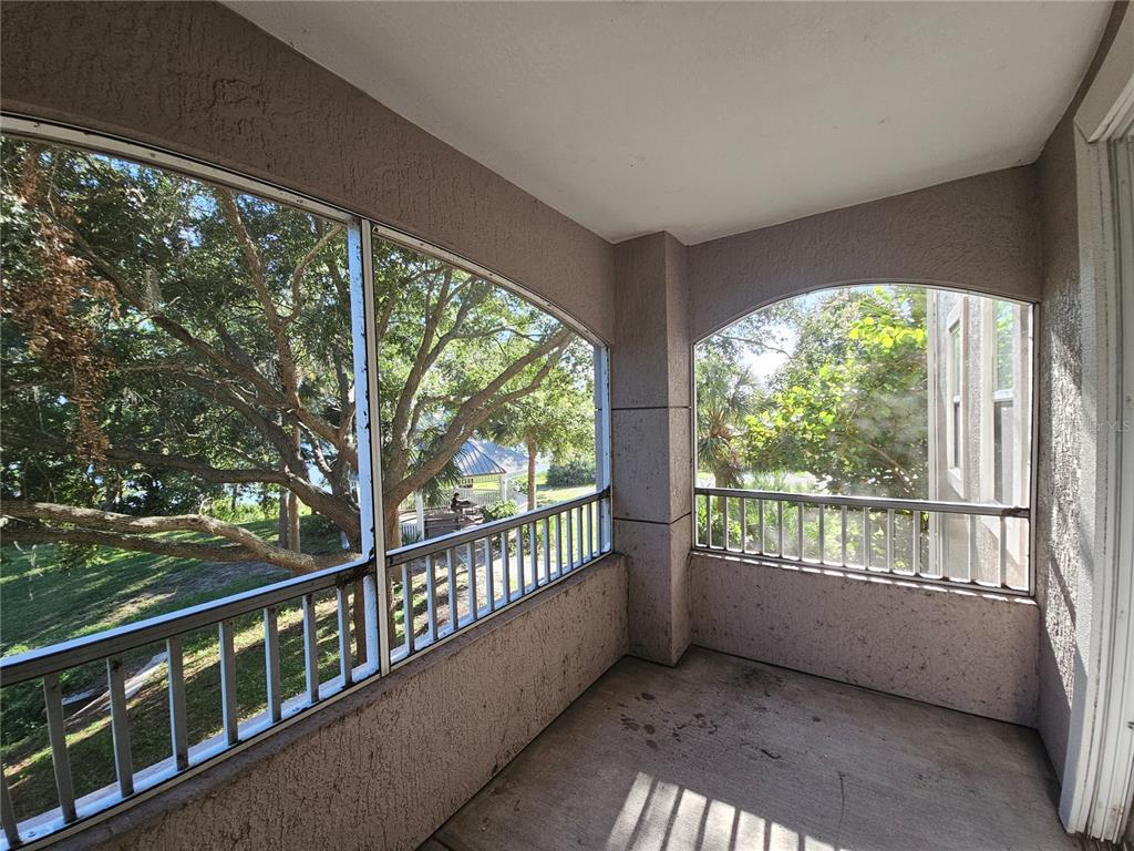 3446 Soho Street, Unit 108 Orlando, FL 32835 - Photo 6 of 39 a view of a porch with wooden floor and outdoor space