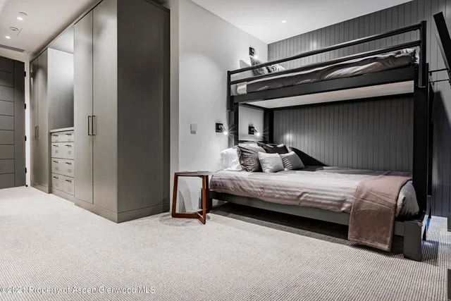 a bedroom with a bed and a mirror