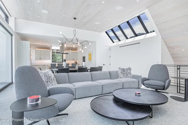 a living room with furniture and a chandelier