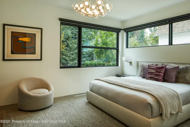 a bedroom with a bed and a chair