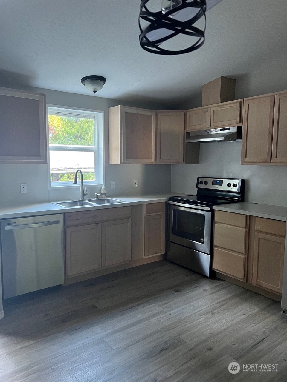 41528 Center Street Concrete, WA 98237 - Photo 7 of 25 a kitchen with stainless steel appliances a sink a stove a window cabinets and a window