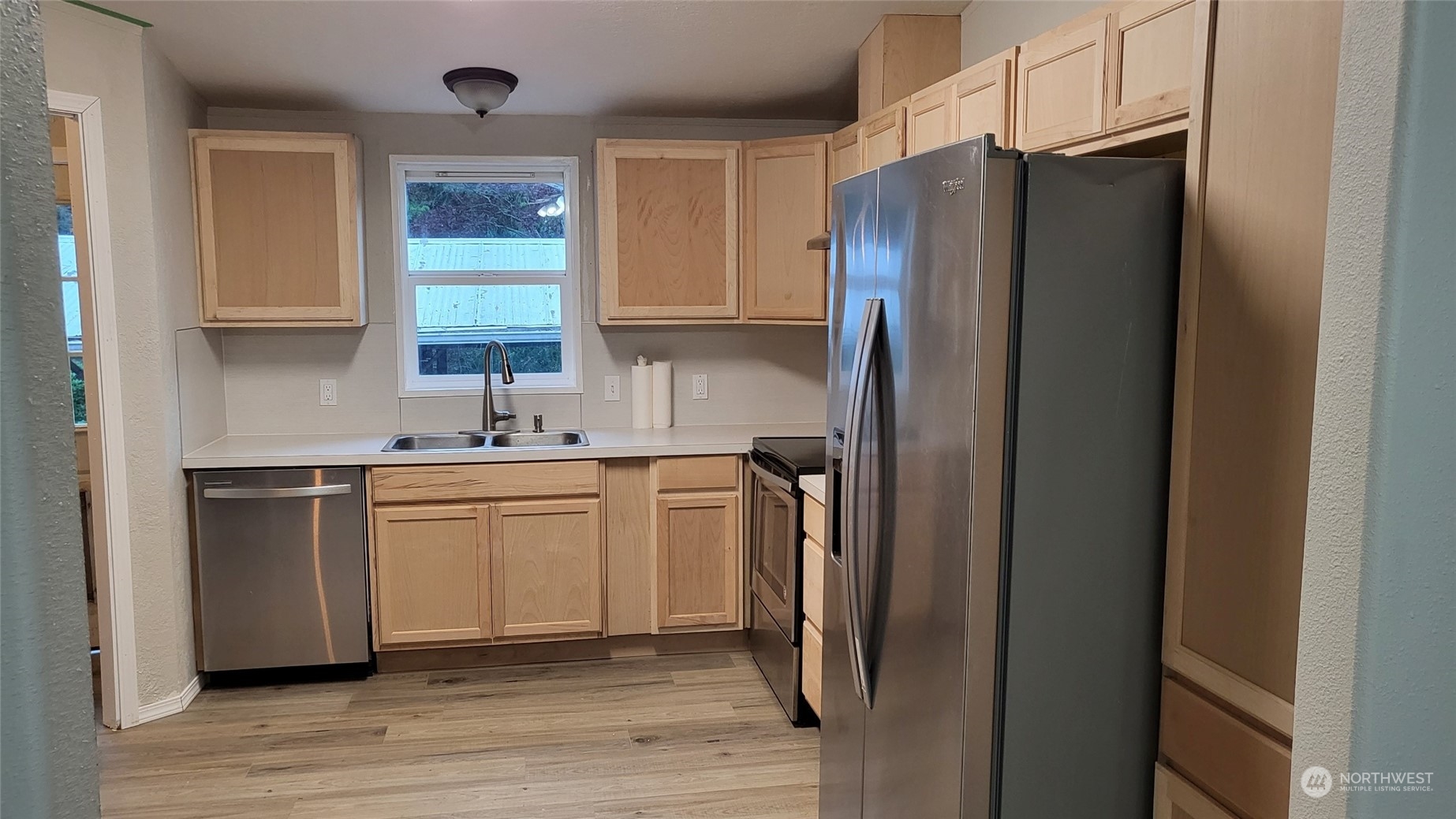 41528 Center Street Concrete, WA 98237 - Photo 8 of 25 a kitchen with stainless steel appliances a refrigerator sink and cabinets