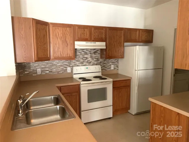 a kitchen with a refrigerator sink and stove
