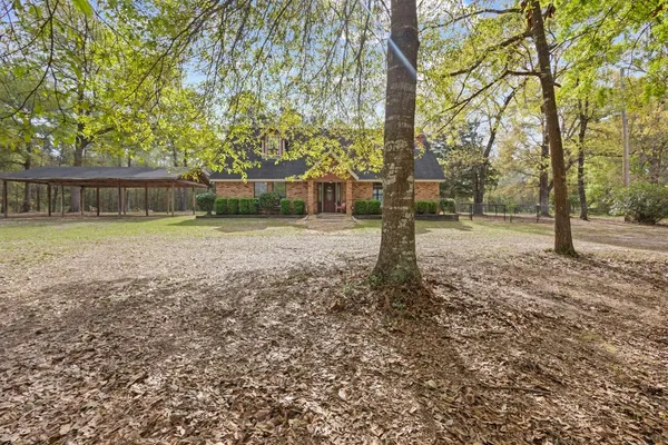 a backyard of apartments with large trees