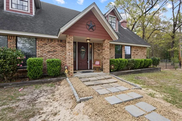 a front view of a house with garden