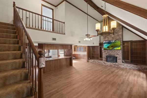 a view of entryway livingroom and hall with wooden floor
