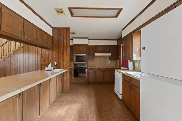 a kitchen with stainless steel appliances a sink and a refrigerator