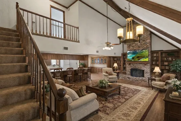 a living room with fireplace furniture and a potted plant