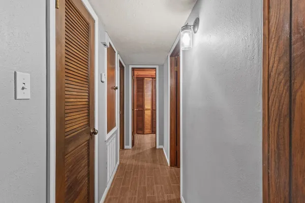 a view of a hallway with wooden floor