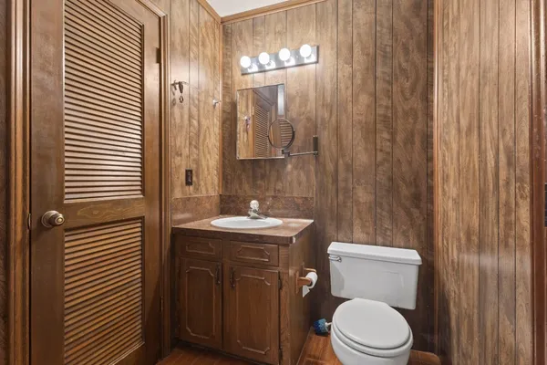 a bathroom with a toilet a sink and mirror