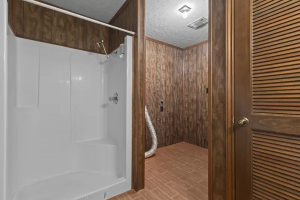a bathroom with a shower and a sink