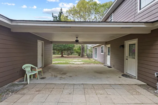 a view of a porch with a table and chairs
