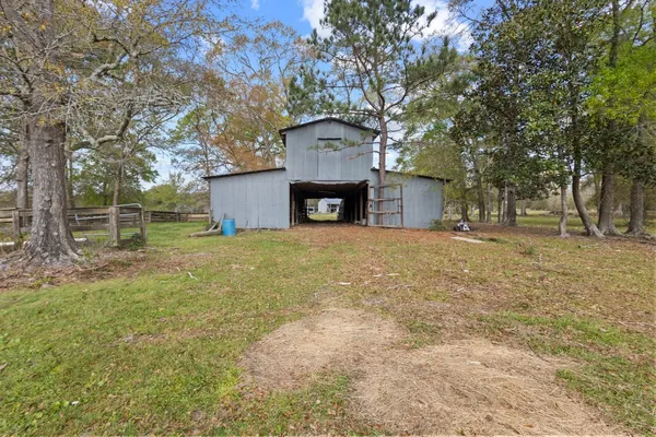 a front view of a house with a garden and tree