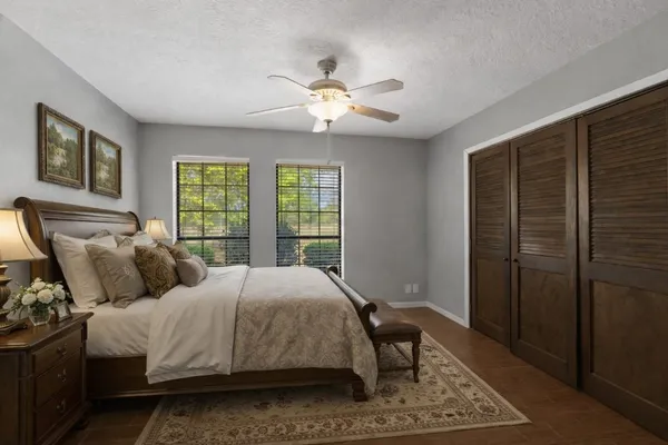 a bedroom with a large bed and a window