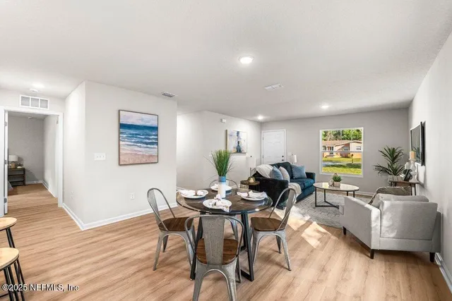 a living room with fireplace furniture and wooden floor