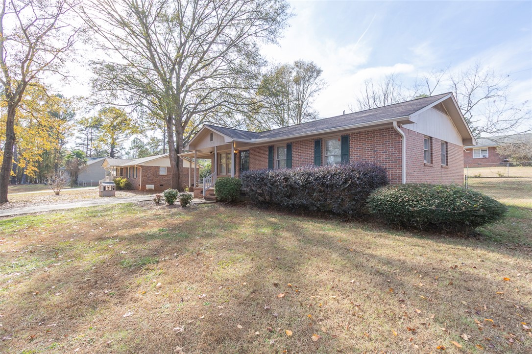 1118 Gilreath Road Anderson, SC 29621 - Photo 9 of 18 This brick ranch offers a charming facade with a welcoming front porch and mature landscaping.