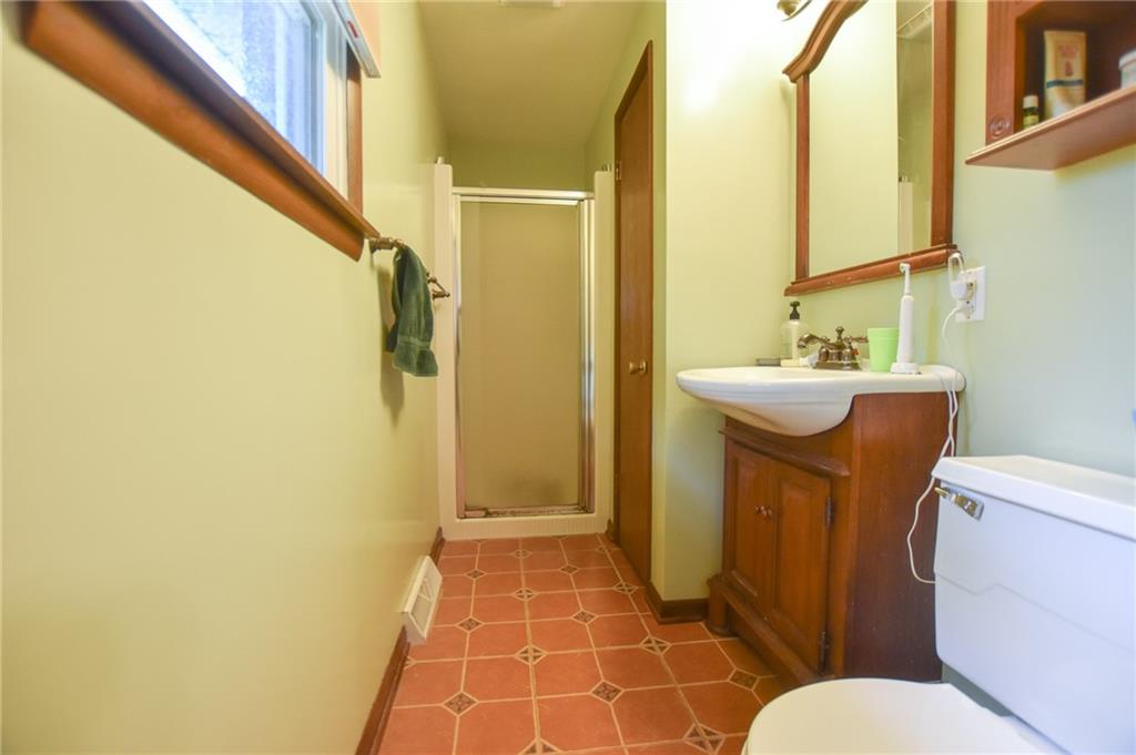 126 Morningside Drive Butler, PA 16002 - Photo 6 of 14 a bathroom with a sink a toilet a mirror and shower