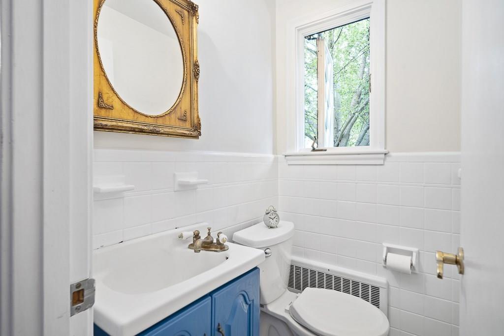 93 Meadowbrook Road Needham, MA 02492 - Photo 23 of 34 a bathroom with a sink a toilet and a mirror