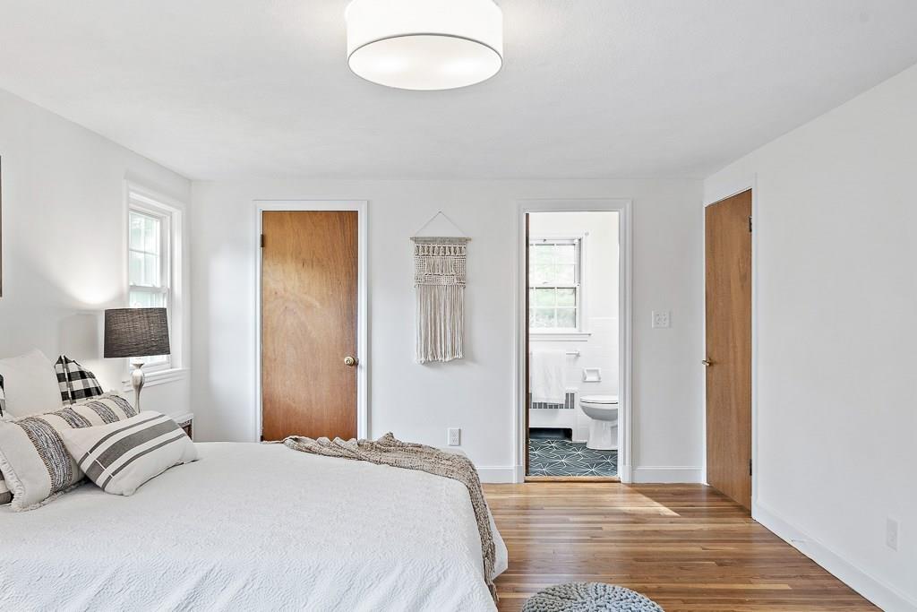 93 Meadowbrook Road Needham, MA 02492 - Photo 25 of 34 a bedroom with a bed and a chandelier