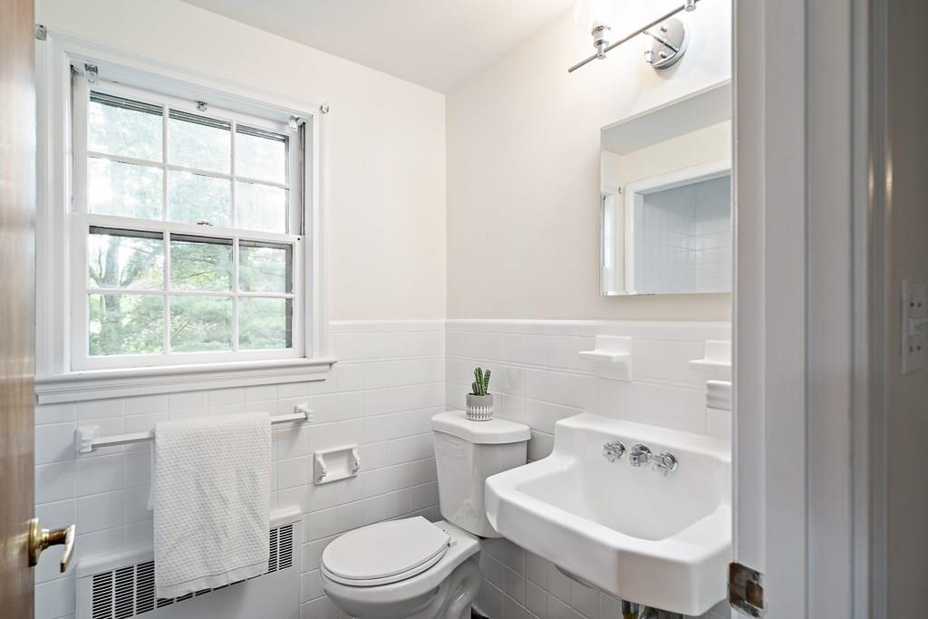 93 Meadowbrook Road Needham, MA 02492 - Photo 26 of 34 a bathroom with a sink a toilet and a mirror