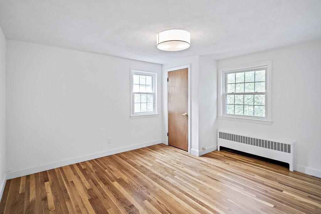 93 Meadowbrook Road Needham, MA 02492 - Photo 28 of 34 an empty room with wooden floor and windows