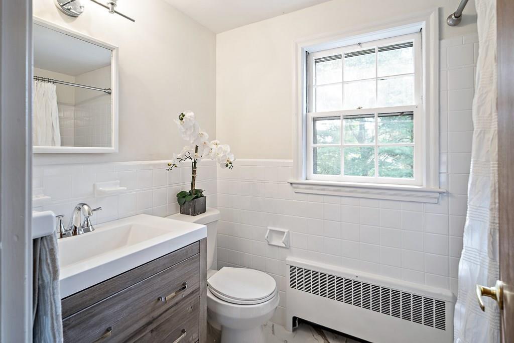 93 Meadowbrook Road Needham, MA 02492 - Photo 29 of 34 a bathroom with a sink a toilet and window