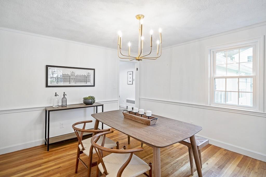 93 Meadowbrook Road Needham, MA 02492 - Photo 5 of 34 a view of a dining room with furniture a chandelier and wooden floor