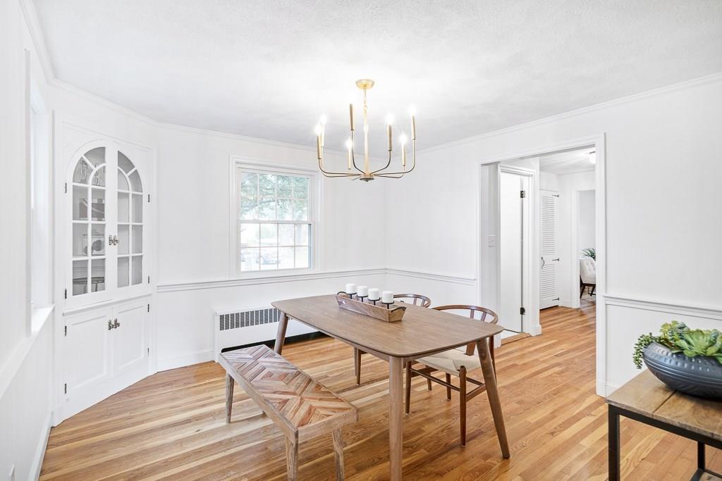 93 Meadowbrook Road Needham, MA 02492 - Photo 6 of 34 a dining room with furniture a chandelier and wooden floor
