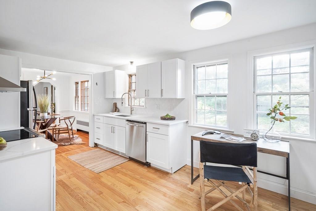93 Meadowbrook Road Needham, MA 02492 - Photo 8 of 34 a kitchen that has a sink a table and chairs in it