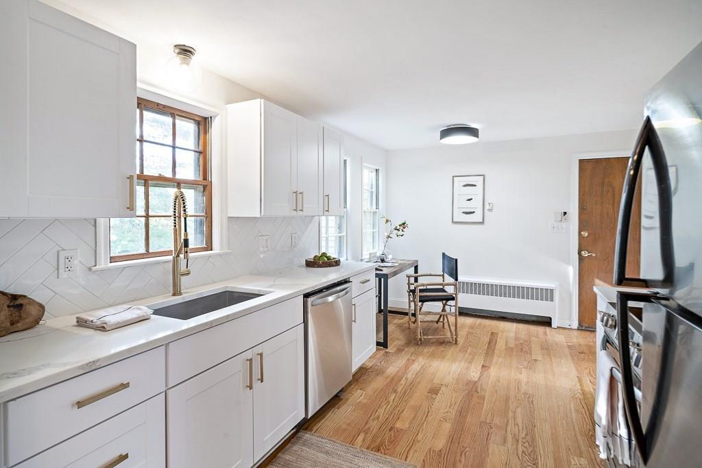 93 Meadowbrook Road Needham, MA 02492 - Photo 10 of 34 a kitchen with sink cabinets and wooden floor