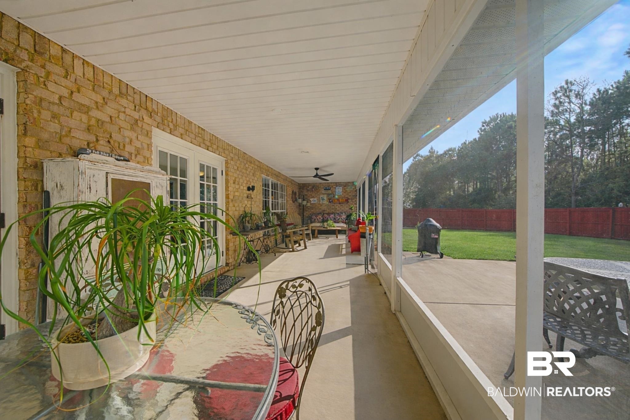 313 Collinwood Loop Foley, AL 36535 - Photo 5 of 36 View of screened porch with a ceiling fan and outdoor dining area