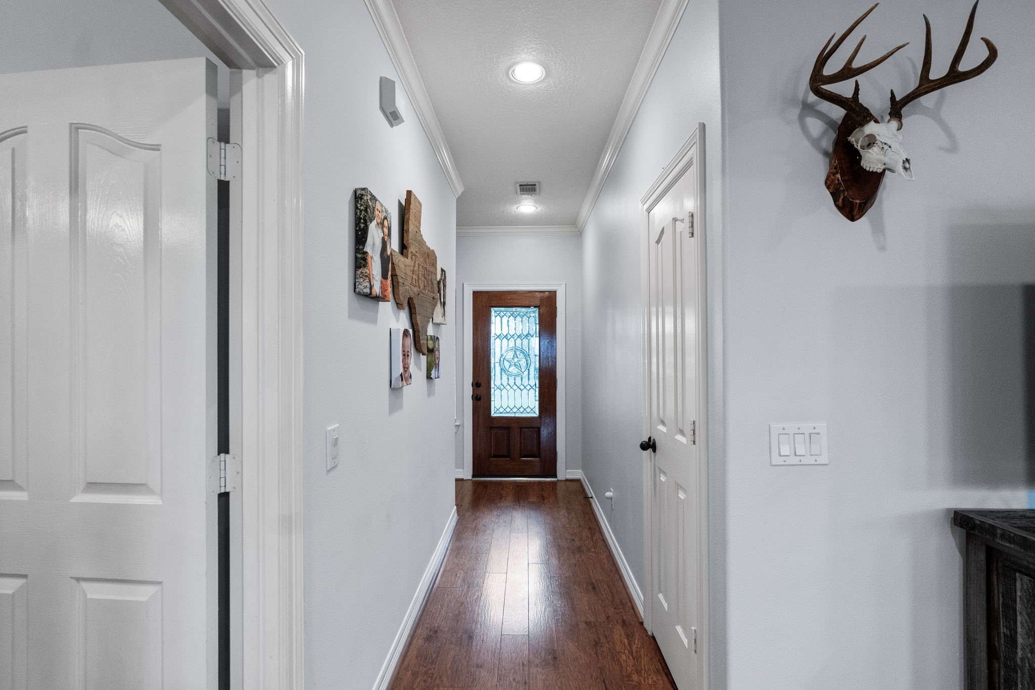 5942 Wildflower Road Sealy, TX 77474 - Photo 4 of 41 a view of a hallway with wooden floor and staircase