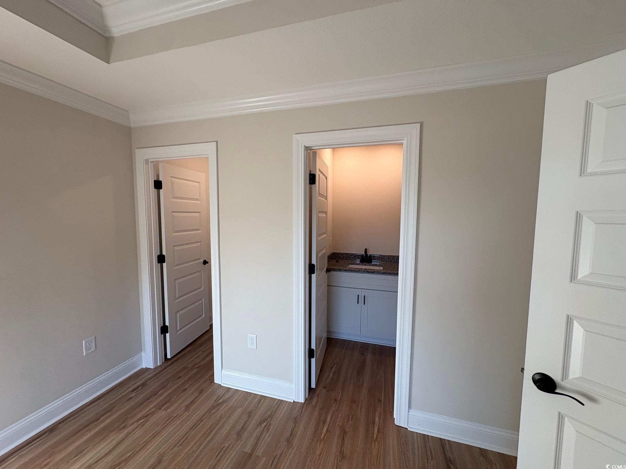 1721 Southern Crest Drive Loris, SC 29569 - Photo 3 of 16 Unfurnished bedroom with crown molding and dark wood-type flooring
