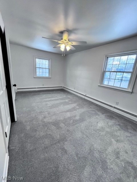 305 Tremont Road Akron, OH 44313 - Photo 16 of 25 Carpeted spare room with a baseboard heating unit, plenty of natural light, and ceiling fan