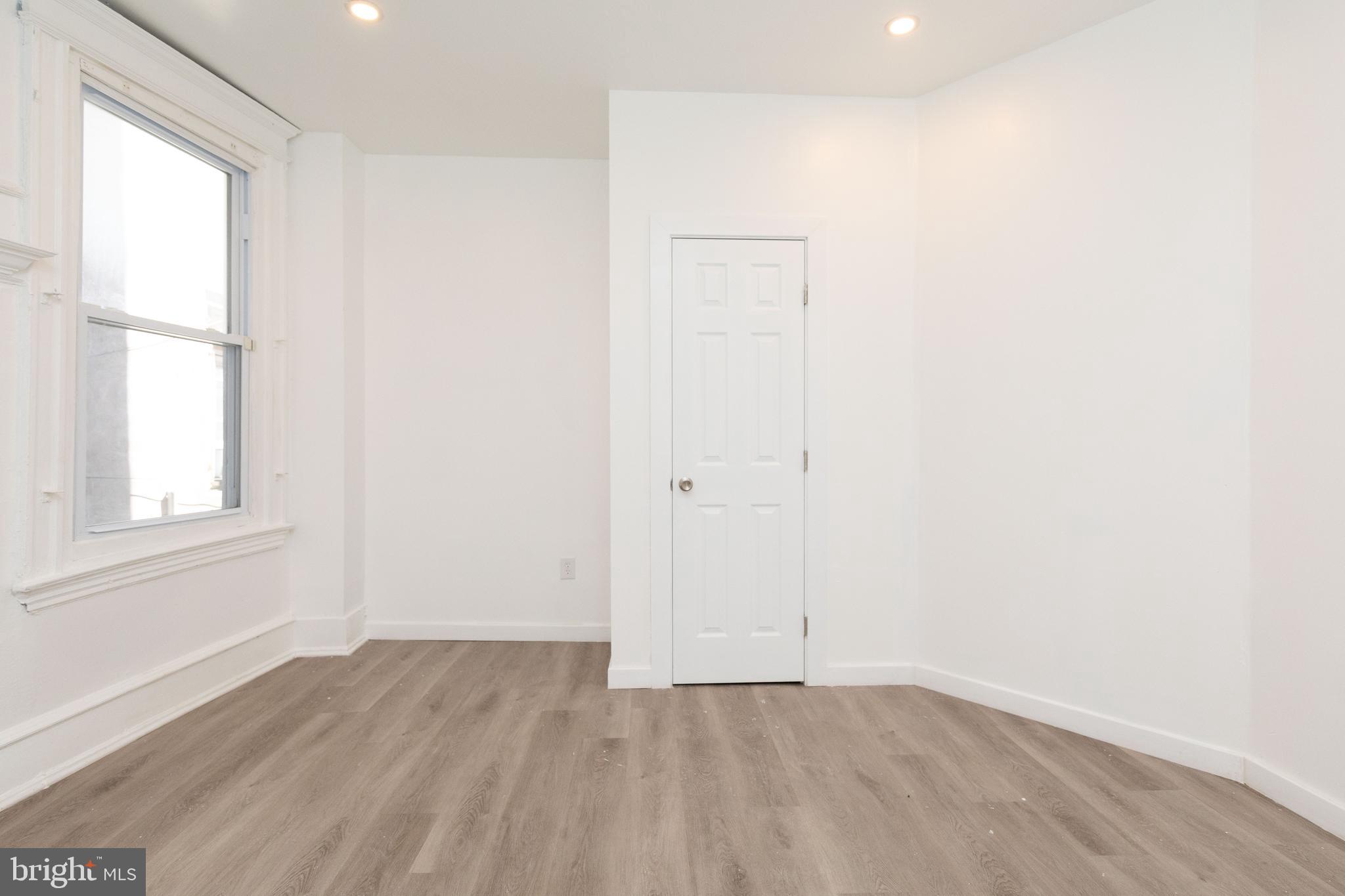 1841 North 33rd Street Philadelphia, PA 19121 - Photo 15 of 29 an empty room with wooden floor and windows