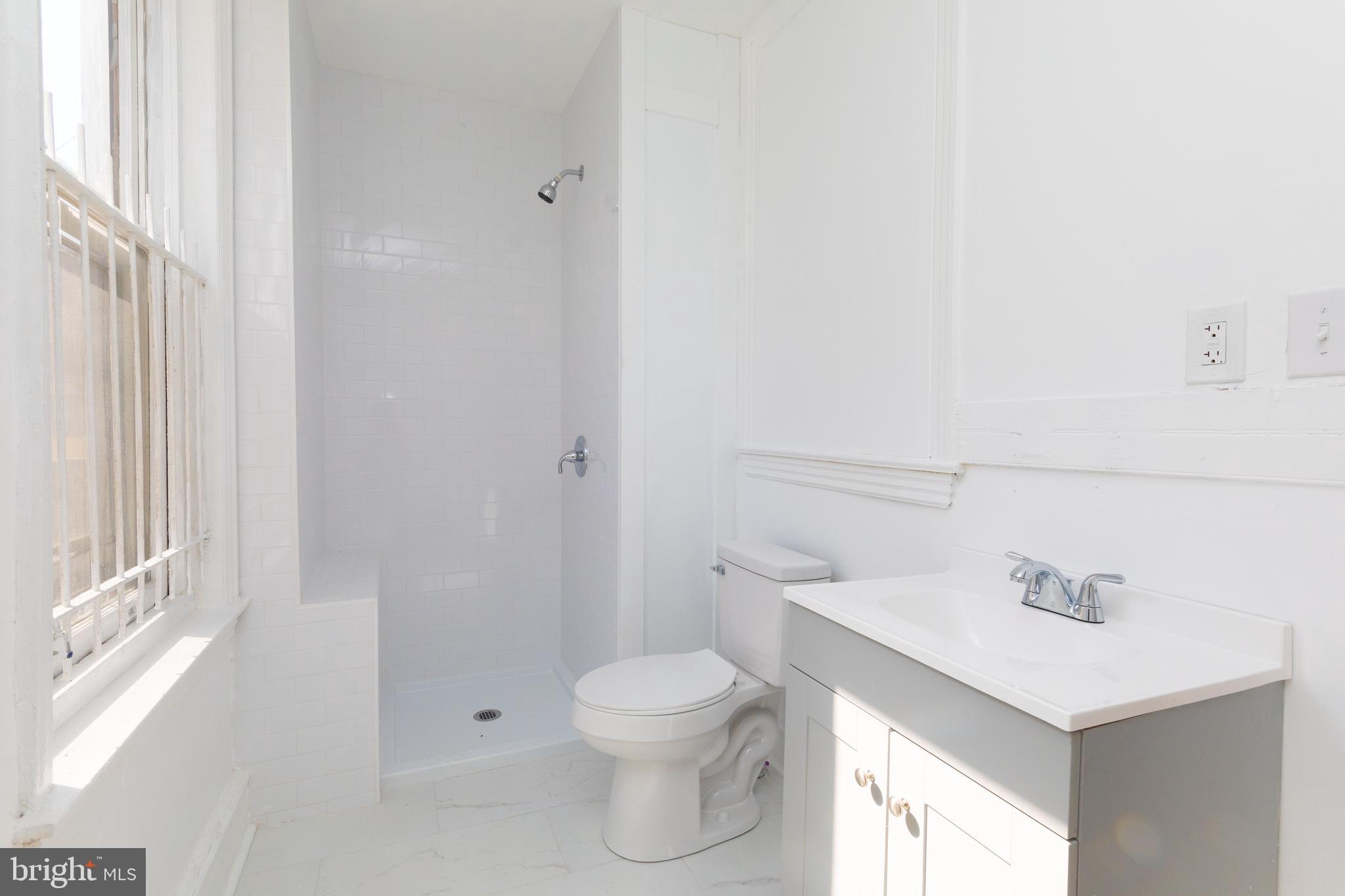 1841 North 33rd Street Philadelphia, PA 19121 - Photo 19 of 29 a bathroom with a sink a toilet and shower