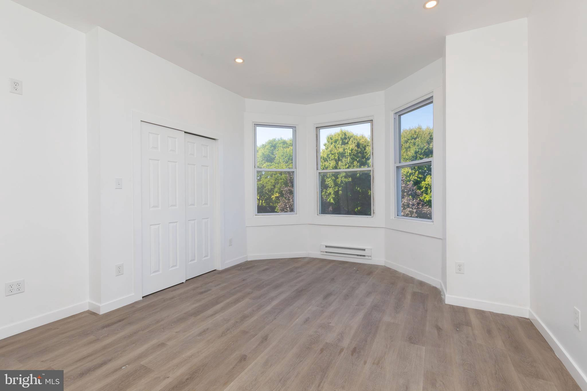 1841 North 33rd Street Philadelphia, PA 19121 - Photo 20 of 29 an empty room with wooden floor and windows