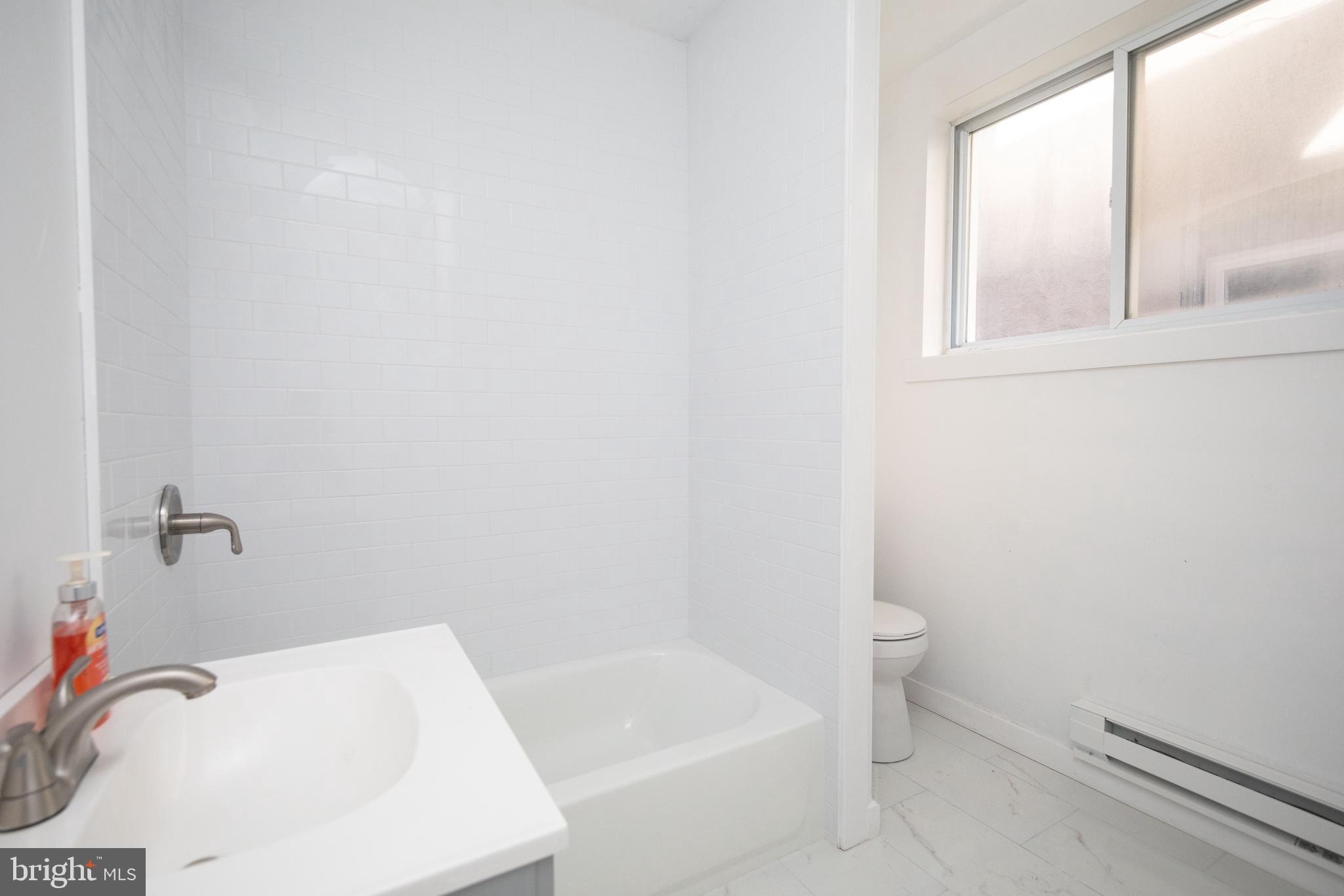 1841 North 33rd Street Philadelphia, PA 19121 - Photo 21 of 29 a bathroom with a sink and bathtub with toilet