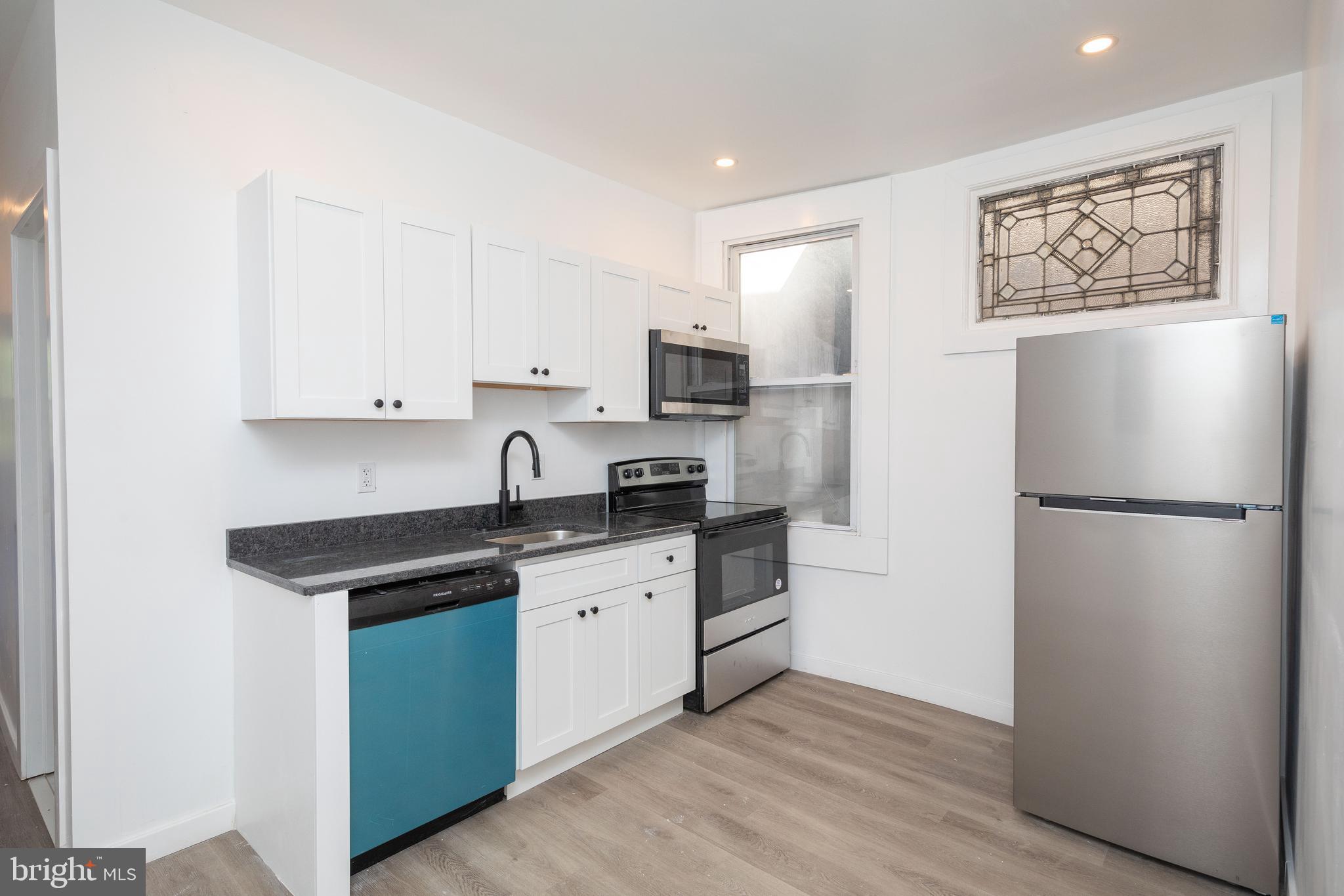 1841 North 33rd Street Philadelphia, PA 19121 - Photo 22 of 29 a kitchen with stainless steel appliances a refrigerator stove and sink