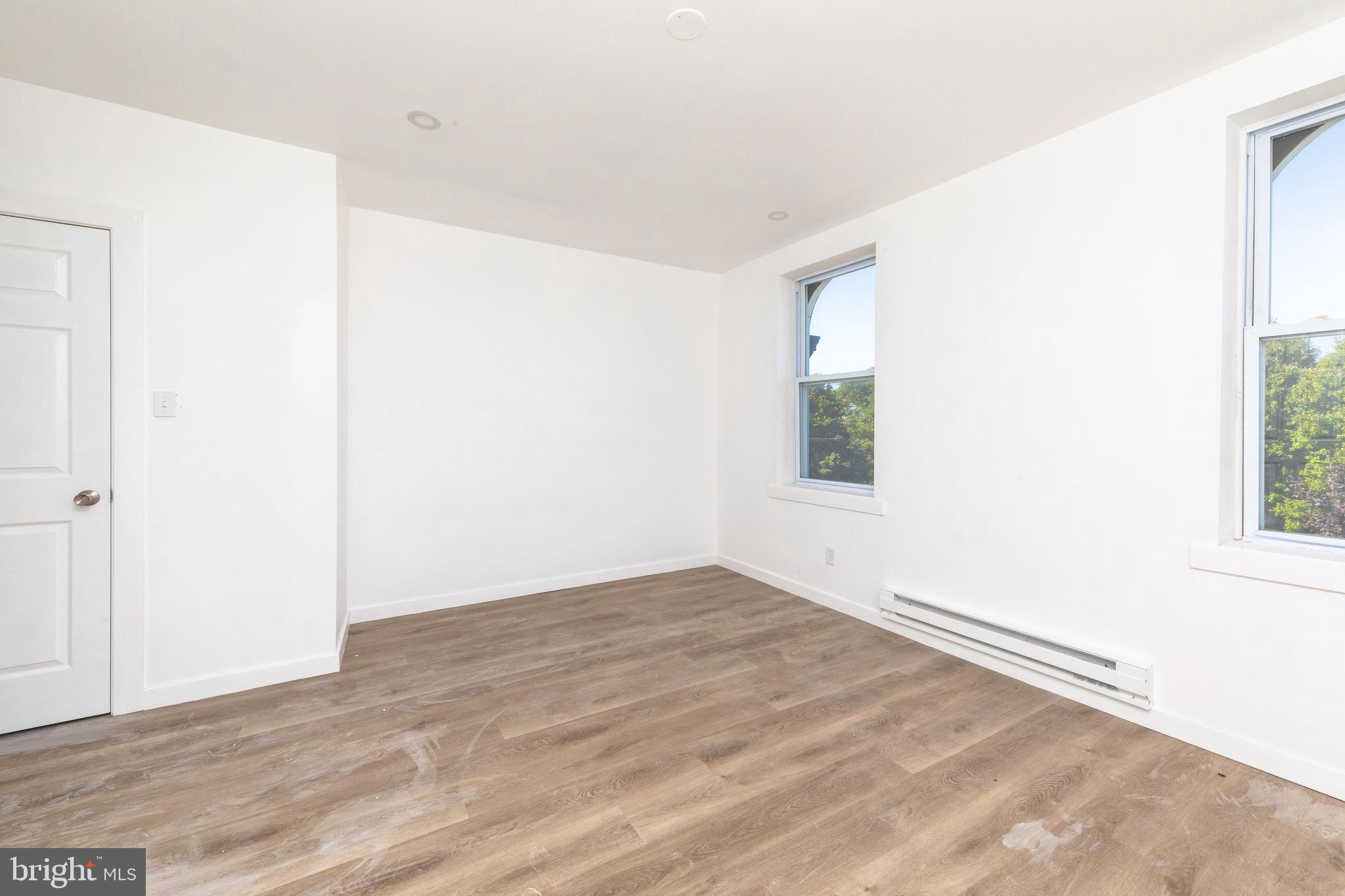 1841 North 33rd Street Philadelphia, PA 19121 - Photo 7 of 29 an empty room with wooden floor and windows